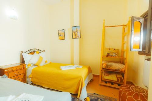 a bedroom with two beds and a mirror at Riad Benyara in Taroudant