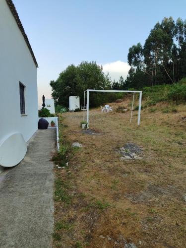 a soccer goal in a field next to a house at Casa Montelouro in Muros