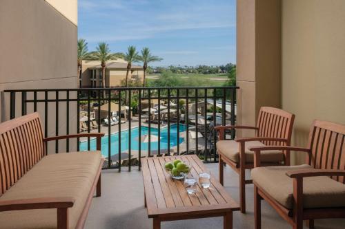 a balcony with chairs and a table and a pool at The Westin Kierland Villas, Scottsdale in Scottsdale
