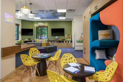 a waiting area with yellow chairs and tables and a living room at The Westin Kierland Villas, Scottsdale in Scottsdale