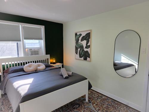 a bedroom with a bed and a large mirror at Byward Market Downtown Guesthouse in Ottawa