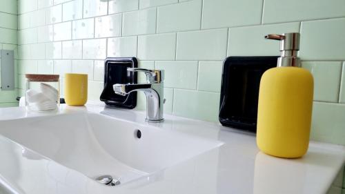 a bathroom sink with a soap dispenser on it at Sunrise in Bergamo