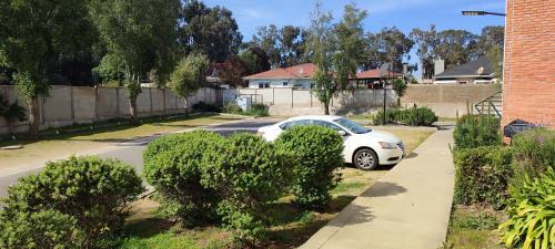 a white car parked on the side of a street at Lindo y cómodo departamento en Algarrobo, Chile in Algarrobo