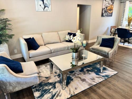 a living room with a couch and two chairs and a table at Luxe Living Prime Location in Kitchener