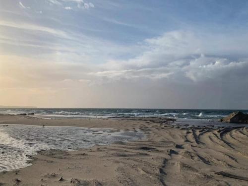 an empty beach with the ocean in the background at 6 person holiday home in Hovborg in Hovborg