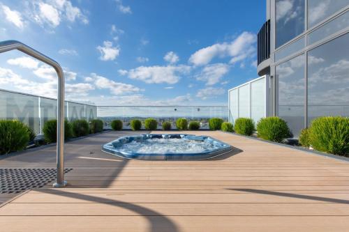 a hot tub on the roof of a building at Elevated Escape - 2BR w Gym & Rooftop Spa in Melbourne