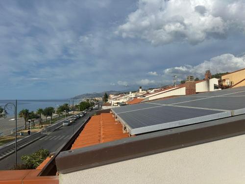 a group of solar panels on the roof of a building at Casa Carmelo in Nizza di Sicilia