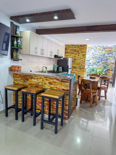 a kitchen with a counter and some tables and chairs at Family Home, 3 minutes from the Airport, parking in La Tebaida