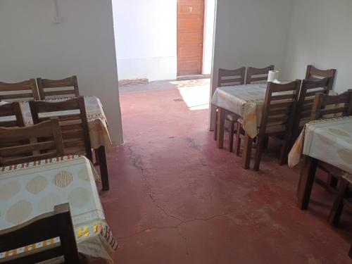 a group of tables and chairs in a room at Hostal O'Higgins in Los Andes
