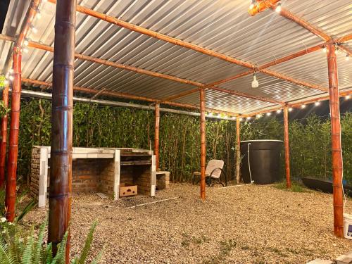 a wooden pergola with a table and a grill at Casa quinta Aluna in Carmen de Apicalá