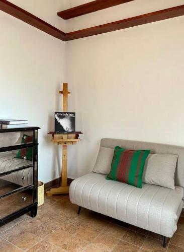a room with a couch and a cross on the wall at Mar de Lava in Mexico City