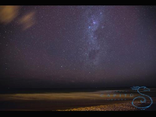 a starry night at the beach with the milky way at Pousada Capitù in Imbassai