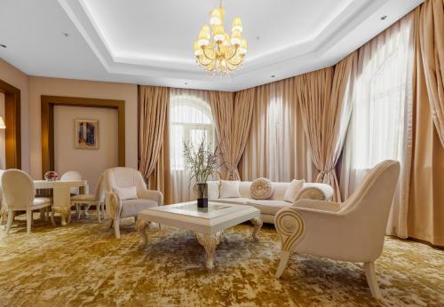a living room with a couch and chairs and a table at Gabala Karvansaray Hotel in Gabala