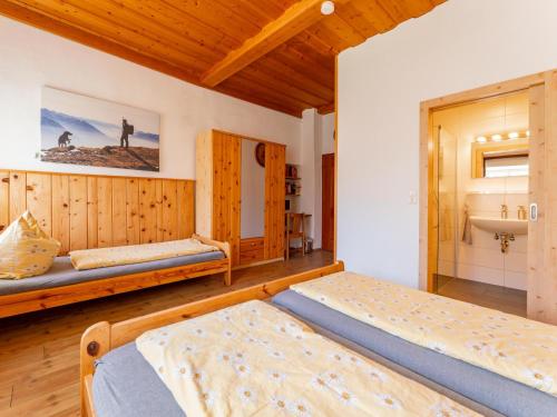 a bedroom with two beds and a sink at Obervellach in Obervellach