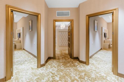 a hallway with two doors and a carpeted floor at Gabala Karvansaray Hotel in Gabala