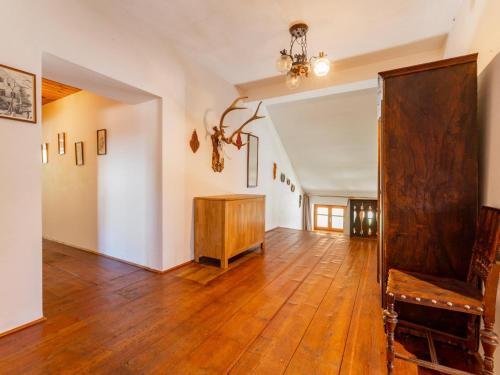 a living room with a wooden floor and a chandelier at Obervellach in Obervellach
