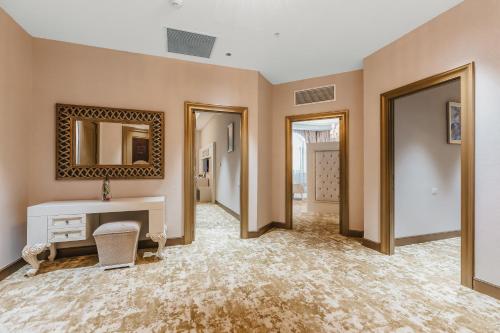 a large room with a desk and a mirror at Gabala Karvansaray Hotel in Gabala