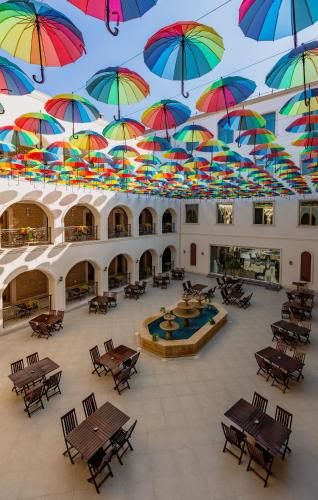 a bunch of umbrellas hanging from a ceiling at Gabala Karvansaray Hotel in Gabala