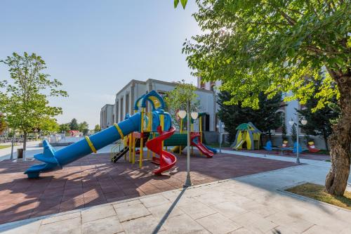 a playground with a blue and red slide at Gabala Karvansaray Hotel in Gabala