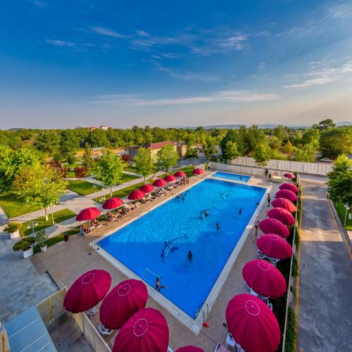 an overhead view of a swimming pool with red umbrellas at Gabala Karvansaray Hotel in Gabala
