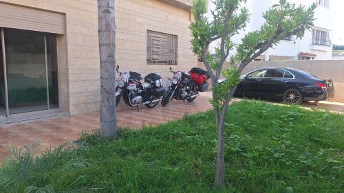 a couple of motorcycles parked next to a building at Suites au sein d'une Villa au centre ville de Rabat in Rabat