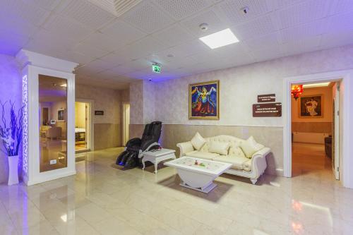 a living room with a couch and a table at Gabala Karvansaray Hotel in Gabala