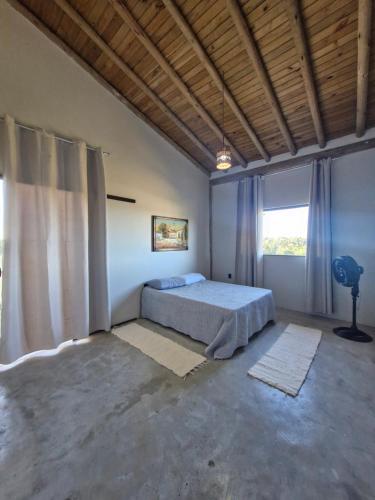 a bedroom with a bed and a large window at A Casa Luna in Porto Seguro