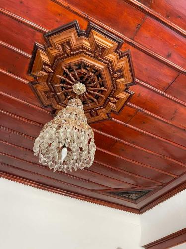 a chandelier hanging from a wooden ceiling at Antique Prizren Home in Prizren