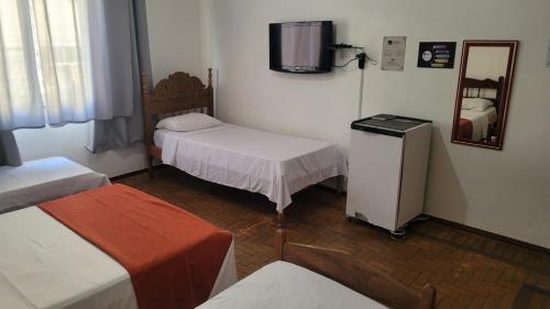 Ένα ή περισσότερα κρεβάτια σε δωμάτιο στο Pousada Barão Real