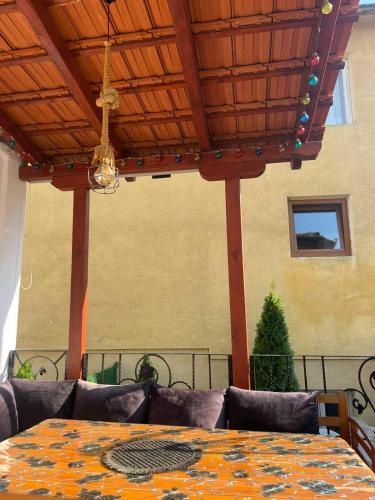 a table with a patterned table cloth on a patio at Antique Prizren Home in Prizren