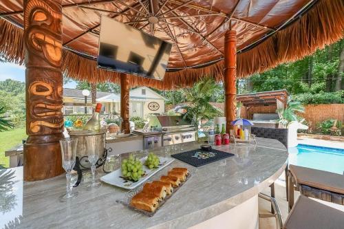 a kitchen with a table with food and a pool at Paradise Oasis in Duluth
