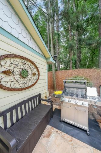 a barbecue grill and a bench next to a house at Paradise Oasis in Duluth
