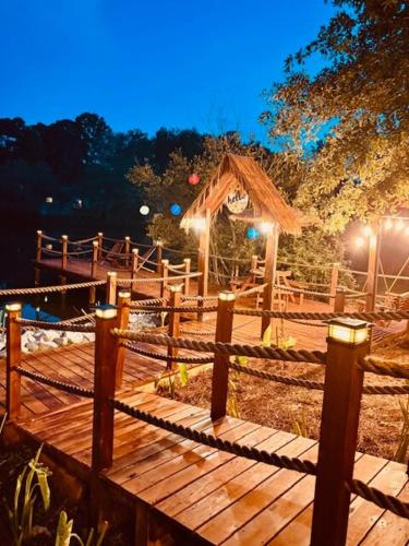 a wooden walkway with a wooden fence and a hut at Paradise Oasis in Duluth
