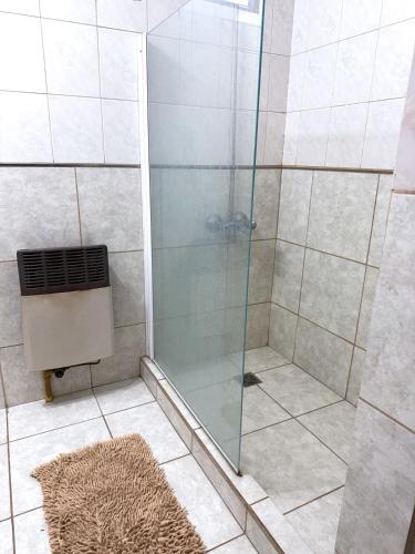 a shower with a glass door in a bathroom at Departamento temporal Mariano in Santa Rosa