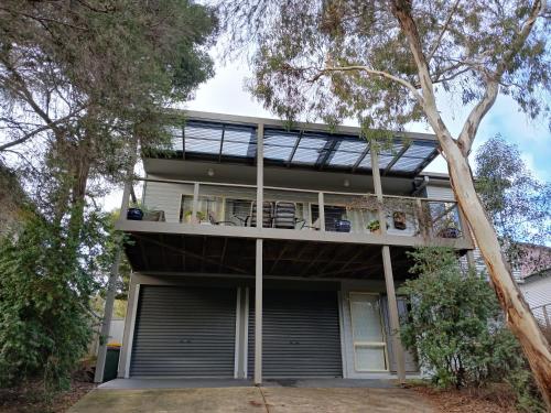 an image of a house with a balcony at Holiday house among native trees overlooking wetlands in Ocean Grove