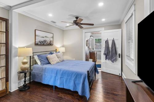 a bedroom with a blue bed and a ceiling fan at Historic Home in Downtown Clinton in Clinton