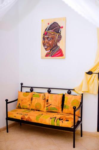 a couch in a room with a painting on the wall at Modern villa with pool views in Ngaparou