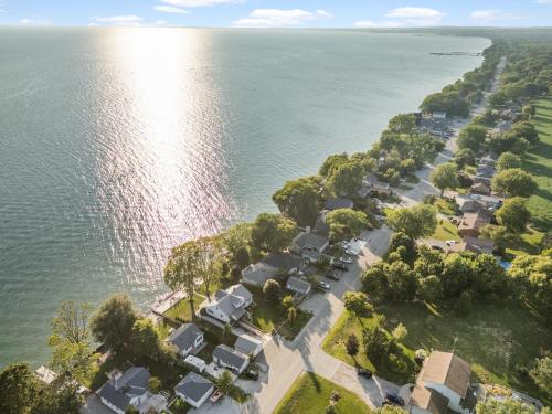 an aerial view of a subdivision of houses next to the water at Birds Eye View on Erie with Hot Tub & Game Room in Leamington