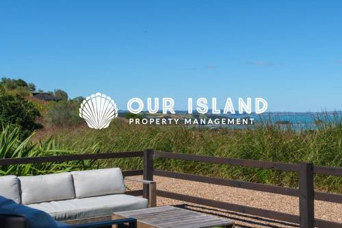 a sign that reads our island property management at Awaawa Yurts - Tāne in Waiheke Island