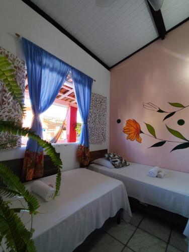 Ένα ή περισσότερα κρεβάτια σε δωμάτιο στο Ray Sol Hostel e Pousada
