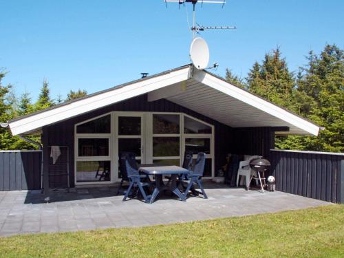 a pavilion with a table and chairs and a grill at 6 person holiday home in Fjerritslev-By Traum in Fjerritslev