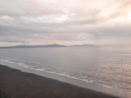 a view of the ocean on a cloudy day at Kampupot Beach Houses in Lemery