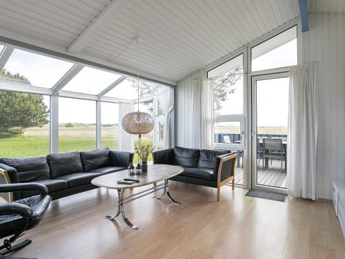 a living room with a couch and a table at Secluded Pool Retreat - By Traum Ferienwohnungen in Jerup