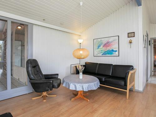 a living room with a couch and a table at Secluded Pool Retreat - By Traum Ferienwohnungen in Jerup