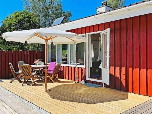 a patio with a table and an umbrella on a deck at 6 person holiday home in Nykøbing Sj-By Traum in Klint