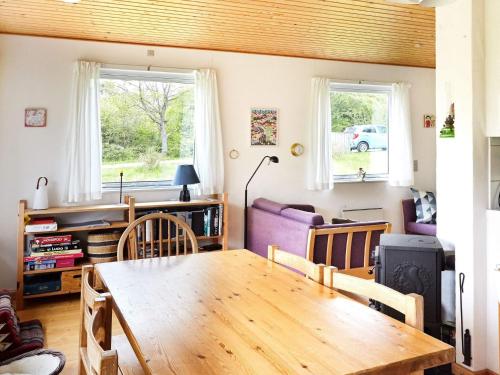 a living room with a wooden table and chairs at 6 person holiday home in Nykøbing Sj-By Traum in Klint
