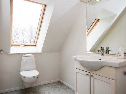 a bathroom with a toilet and a sink and a window at 16 person holiday home in Haderslev-By Traum in Haderslev