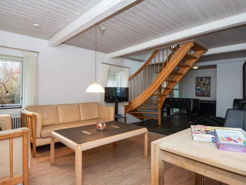 a living room with a couch and a staircase at 16 person holiday home in Haderslev-By Traum in Haderslev