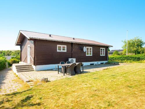 a small house with a table in front of it at 6 person holiday home in Nordborg-By Traum in Nordborg