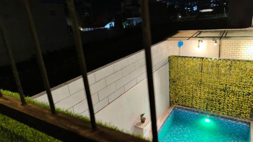 a swimming pool in the middle of a building at night at Villa Pondok Kelapa Batu in Batu
